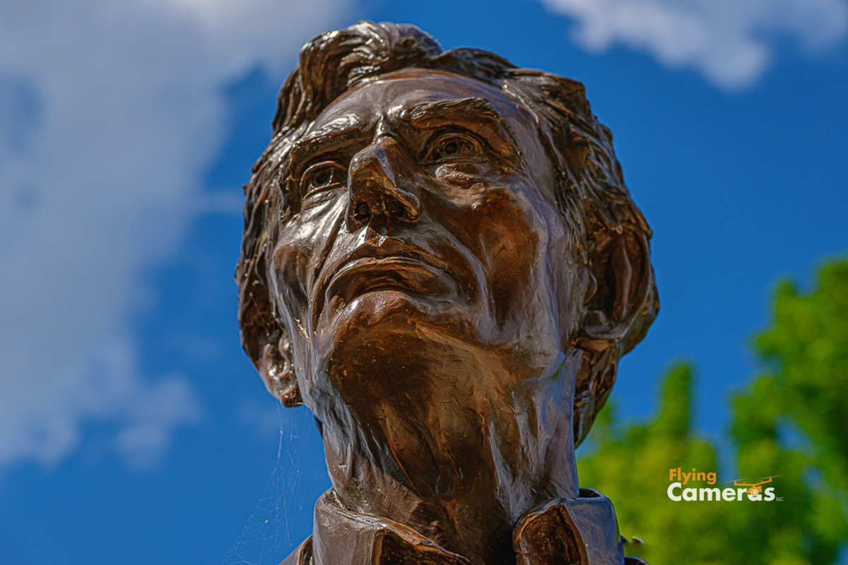 Bronze bust of Abe Lincoln with a blue sky background