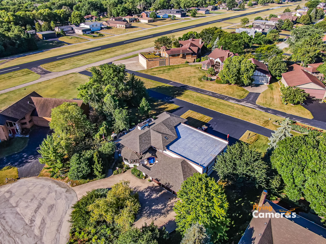 Aerial drone image of home and airport runway on a sunny day