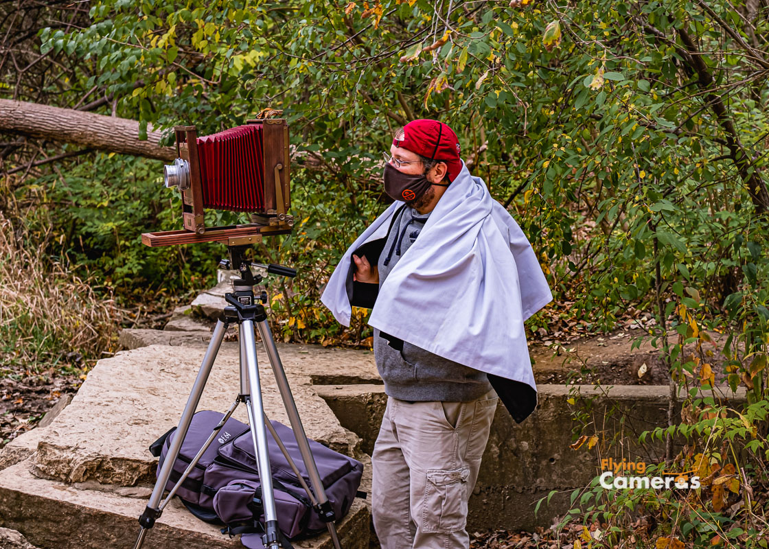 Photographer with accordian camera in Covid eera