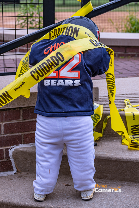 Uniformed Chicago Bears doll wrapped in caution tape