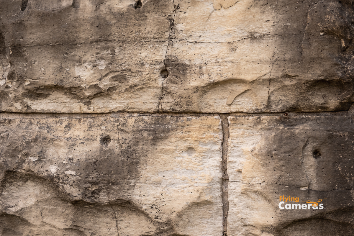 Stonewall with drilling holes from quarry in Lemont