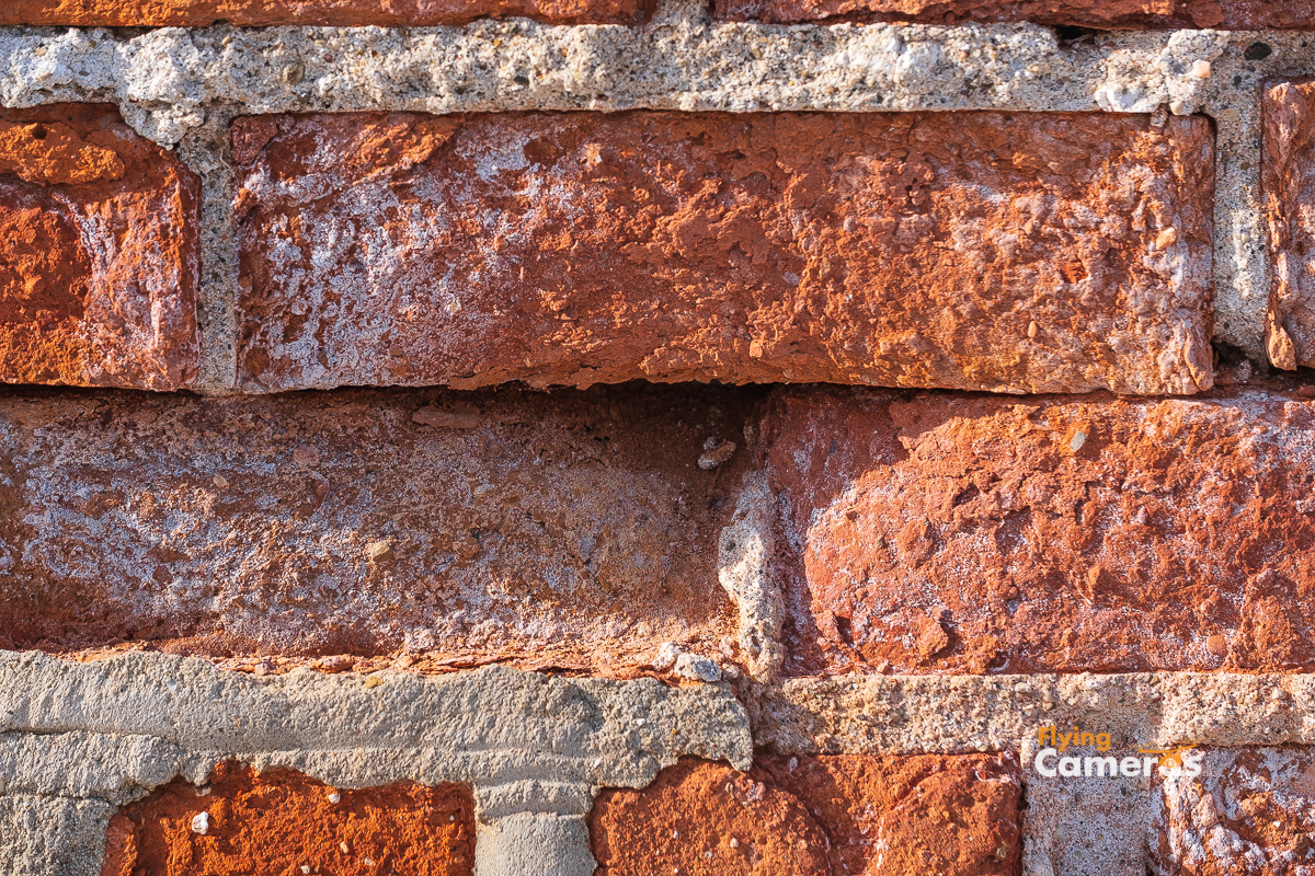 Rust color brick texture in sun