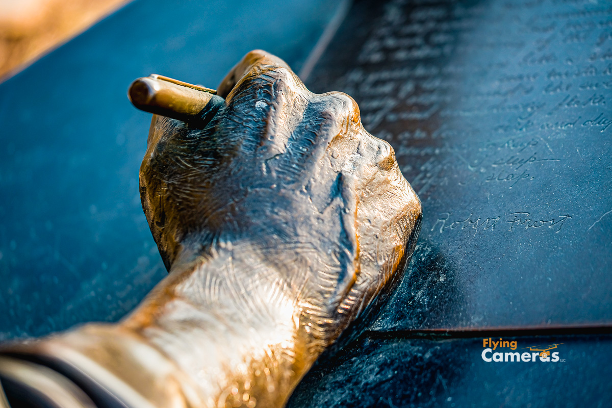 Closeup of  bronze Robert Frost hand signing his name