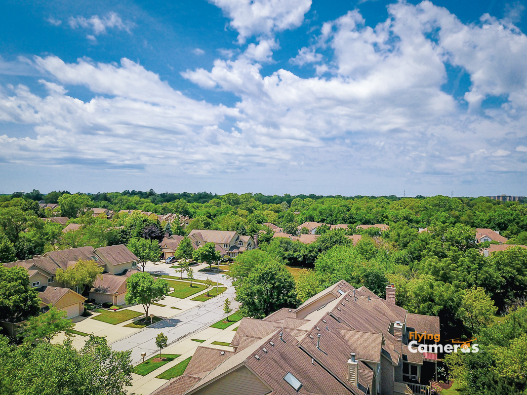 Blue sky with white clouds on a sunny day capture a Bending Oaks subdivision from a drone at 75'