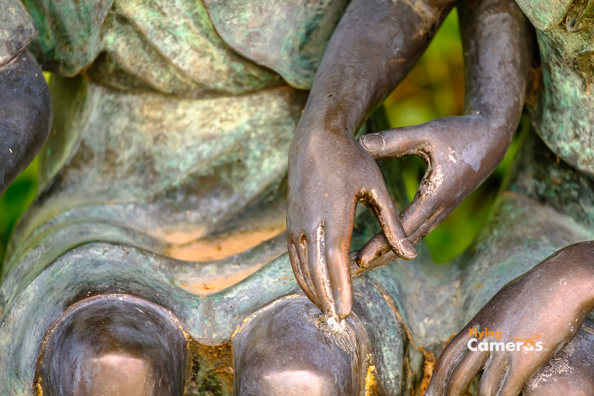 Bronze statue of two girls hands about to clasp each other